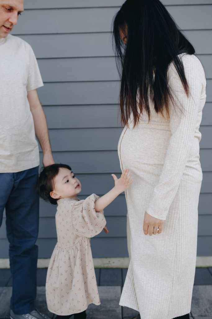 little girl holding her mom s tummy